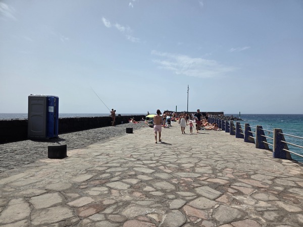 El muelle y el espigón de piedra volcánica que protegen la bahía del Puertito.