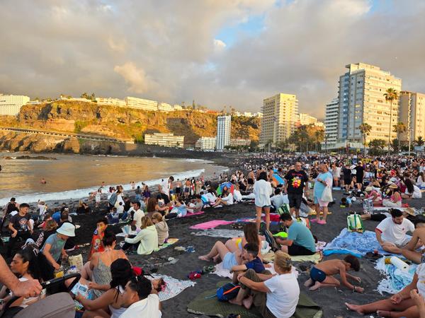 La playa de Puerto de la Cruz se llena de público al atardecer para recibir el solsticio de verano.
